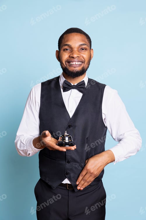 Preview: Hotel porter doorman showing the service bell to ask for his help with luggage