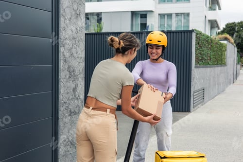 Preview: Smiling Latin courier on electric scooter handing package to client at home door