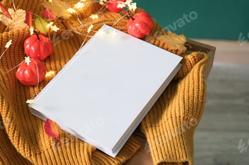 Preview: High angle view of white book on wooden decorative table with fairy lights