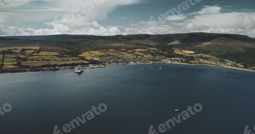 Preview: Brodick ocean ferry pier aerial view: ships, boats and sailboat on ocean bay at Scottish harbor