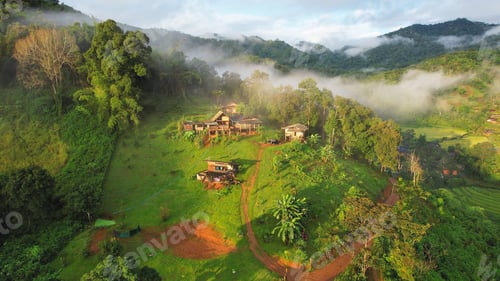 Preview: Aerial view from drone of the rural village in the mountains on foggy day