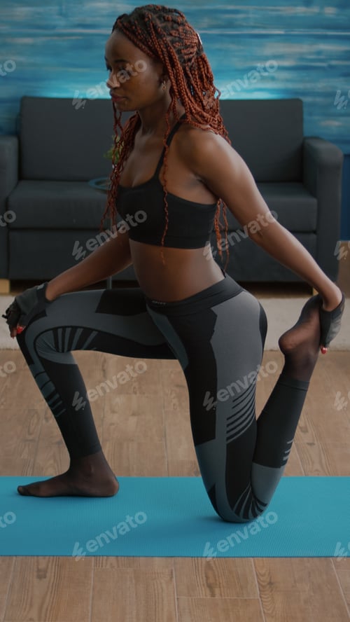 Preview: Fitness woman with black skin practicing fitness workout in living room