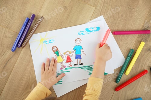 Preview: Little girl drawing with marker on floor, top view. Child`s art