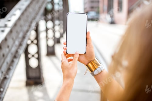 Preview: Holding smartphone on the bridge