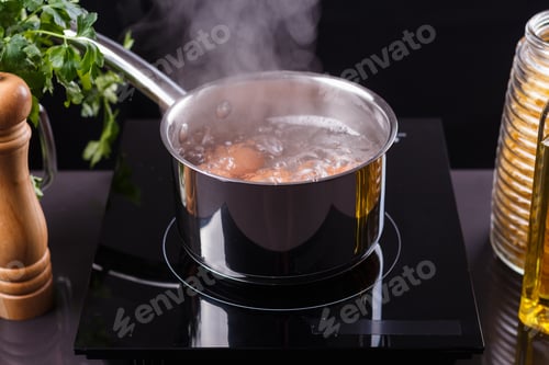 Preview: young woman in an gray apron boiled eggs