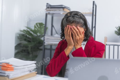Preview: Confident Asian elderly old businesswoman tired stressed suffering from headache at work with laptop