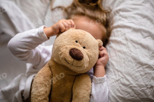 Preview: little girl in bed with soft toy the emotions of a child