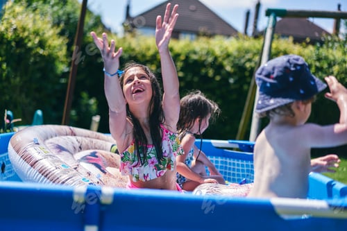 Preview: Children playing in inflatable pool