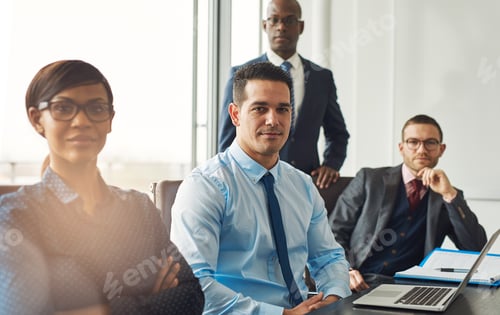 Preview: Smiling confident business team seated at a table