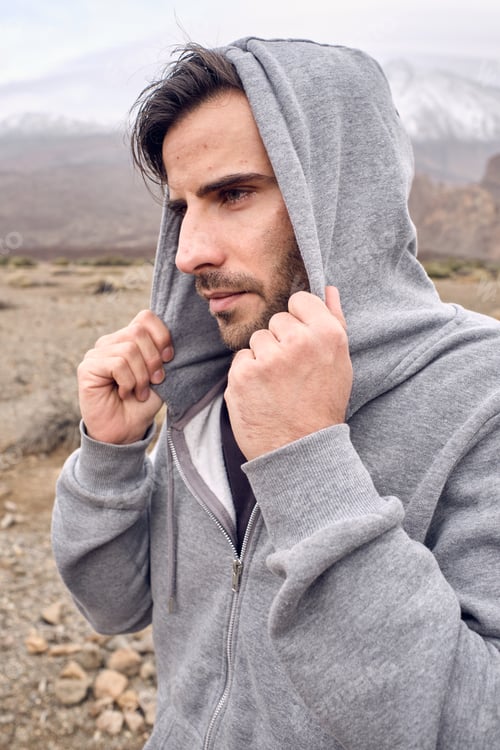 Preview: Hispanic man in hoodie in mountains