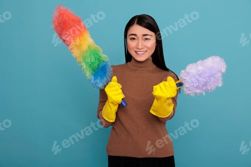 Preview: Optimistic joyful and smiling asian young housemaid from homework