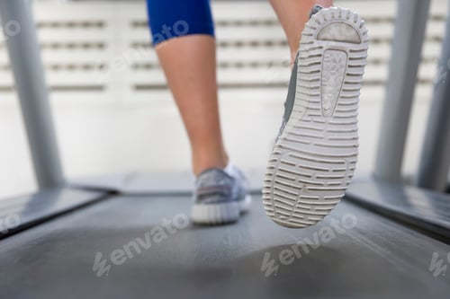 Preview: Fitness girl running on treadmill