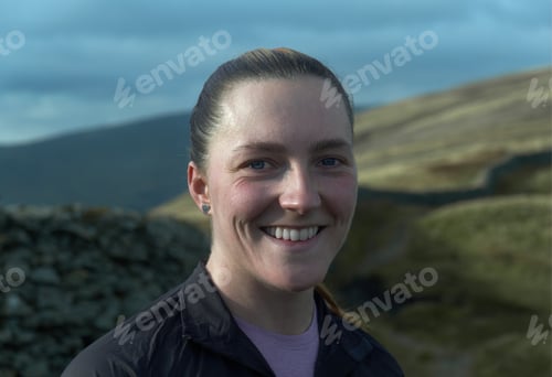 Smiling Woman Outdoors in a Mountain Setting