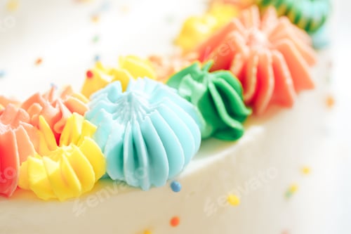 Preview: Background of white cake with colorful cream closeup