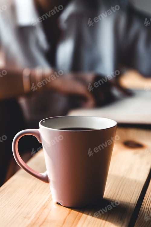Preview: Woman in the morning drinks coffee and reads old book in a white shirt. Education, drink. manicure