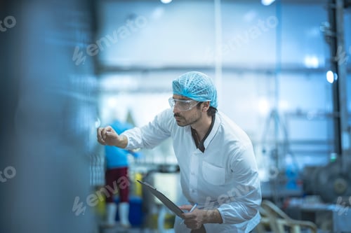 Preview: Inspector reviewing production processes in a clean facility