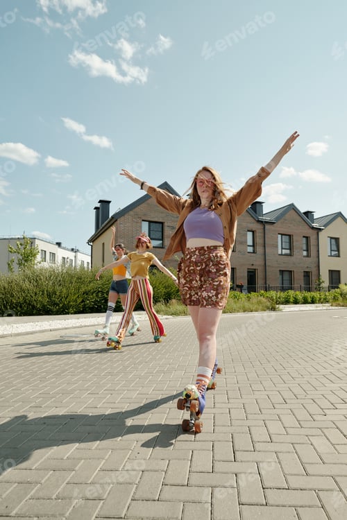 Preview: Cute female zoomer in casualwear moving forwards on roller skates