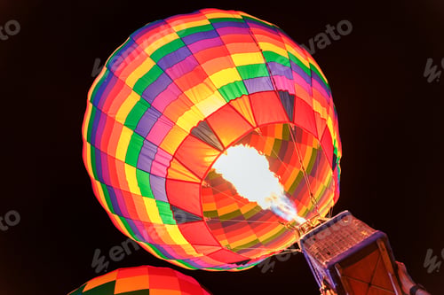 Preview: Colorful hot air balloon with flame burning in the night