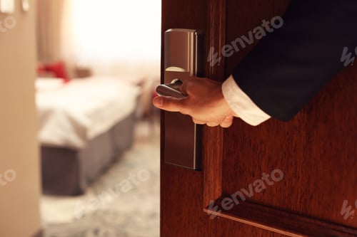 Preview: Hand of businessman opening hotel room