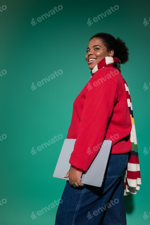 Preview: Stylish plus size African American woman showcases trendy autumn fashion in studio
