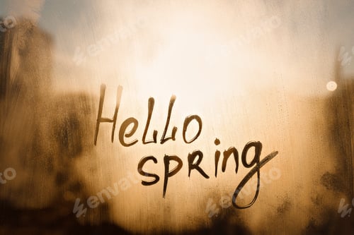 Preview: Handwritten text Hello spring on wet orange window
