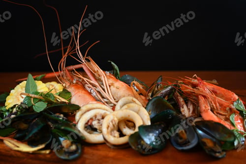 Preview: Mixed sea food on the wooden plate with black background.
