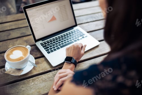 Woman in cafe using latest technology devices