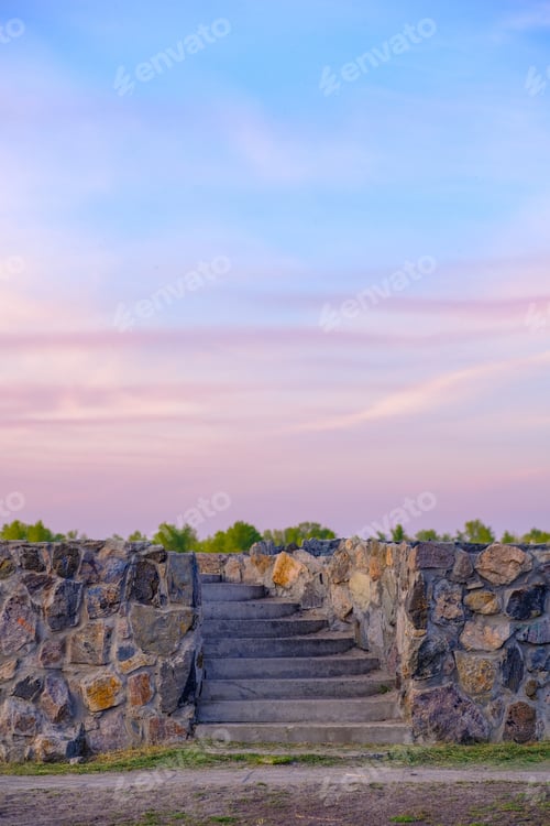 Preview: Beautiful summer sunset pink sky with stone stairs. Empty space.