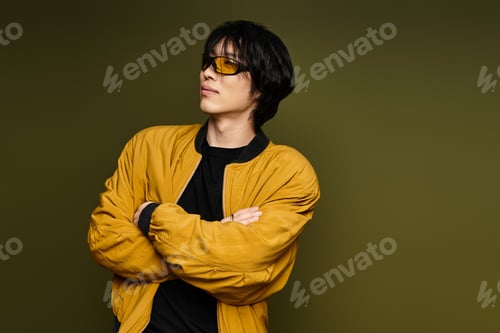 Preview: Young man showcases contemporary fashion in a vibrant studio with unique patterns