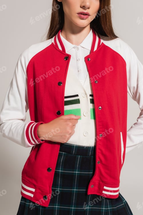 Preview: cropped view of woman in white and red jacket posing isolated on grey