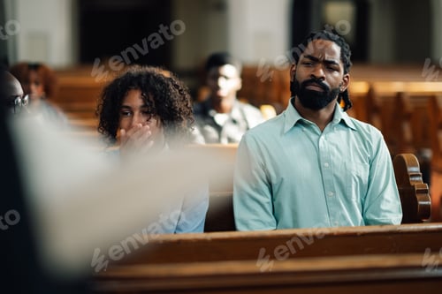 Preview: Congregation members sitting in church pew listening to sermon