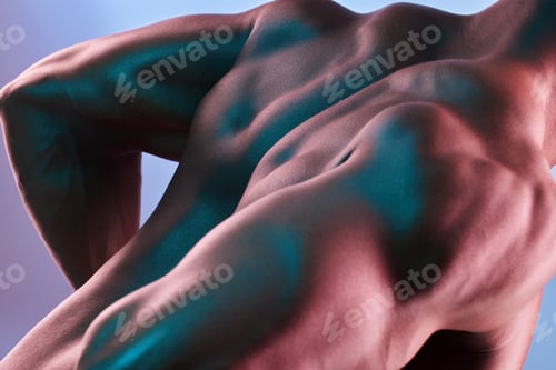 Preview: Shot of a muscular man posing against a studio background