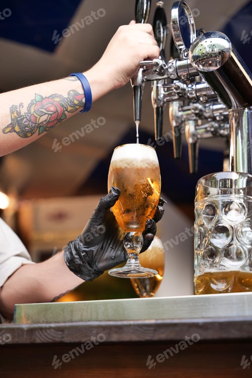 Preview: bartender tapping beer in a pub