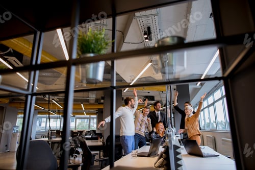 Preview: Happy young business people standing in the office and looking forward to success in the office