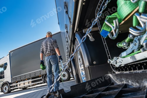 Preview: Professional Semi Truck Driver Working on Back of Truck