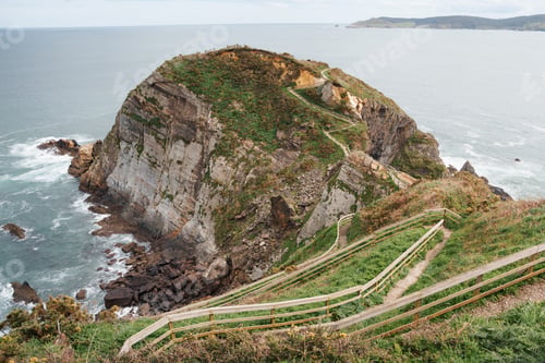 Preview: A scenic wooden walkway descends along the rugged cliffs of Galicia, ideal for travel and adventure.