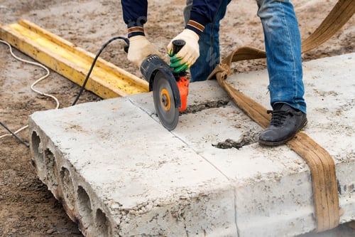 Preview: Close up worker cuts concrete with circular saw