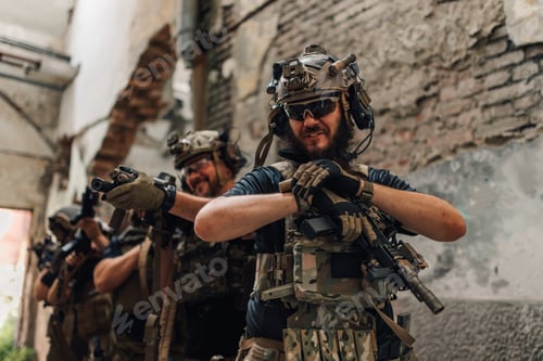 Preview: Group of air soft players in uniforms and weapons preparing for action