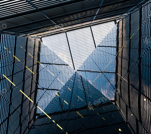 Preview: Low angle shot of a geometrical design of a building with beautiful reflections on glass windows