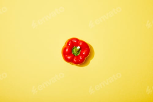 Preview: top view of red paprika on yellow background