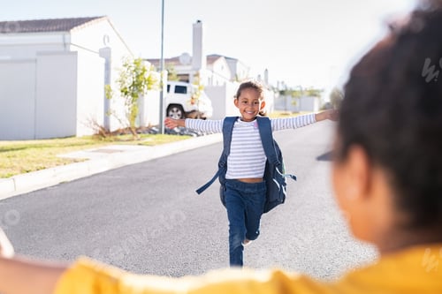 Preview: Little elementaty student girl running to mother after school