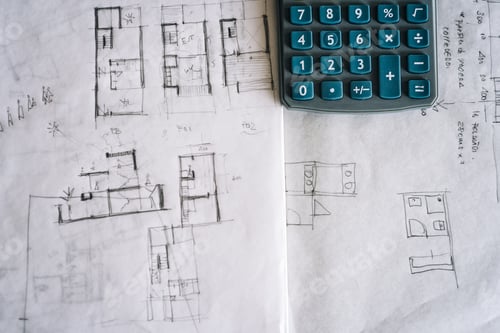 Preview: Architect sketches on paper and calculator on office desk.