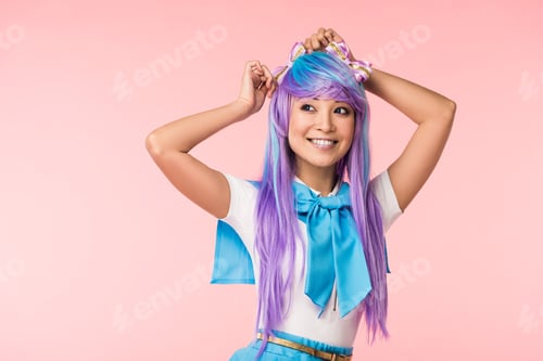 Preview: Smiling asian otaku girl in purple wig standing on pink