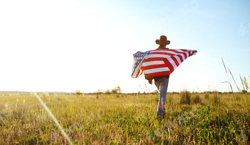 Preview: Traveler with the flag of America. The man in a hat, a backpack