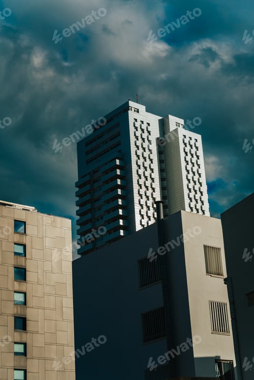 Preview: Dramatic cloudy sky over the tall buildings of an urban city.
