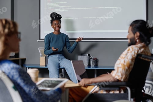 Preview: African American Coder Interacting with Colleagues While Showing Presentation