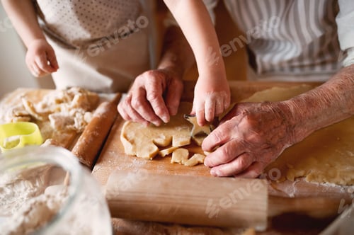 Preview: Midsection of grandmother with small toddler boy making cakes at home.