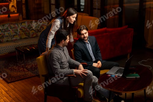 Preview: sitting in yellow chairs two male workers discuss a project a female director scolding for mistakes