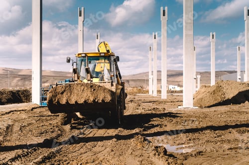 Preview: Industrial backhoe excavator and loader carrying earth and working on construction site