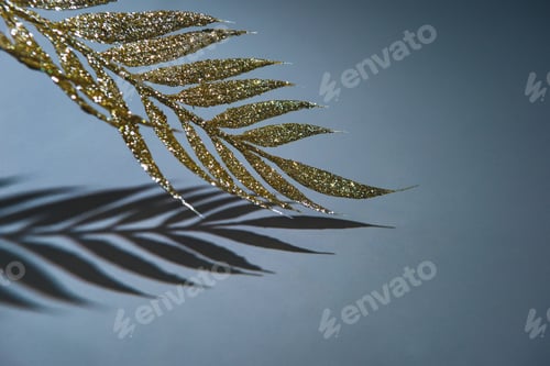 Preview: golden branch decorated by glitter and shadow, christmas background concept
